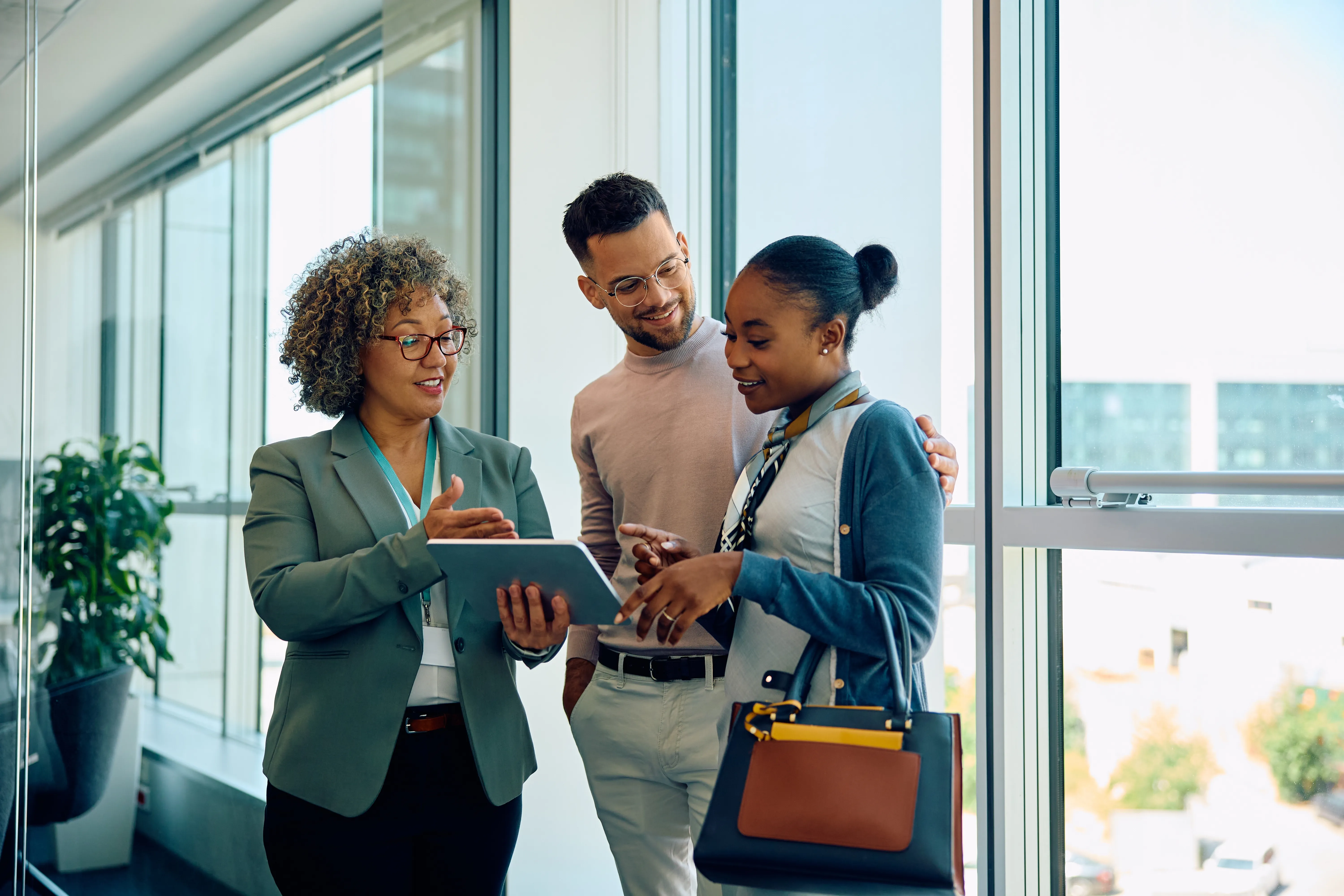 Conseillère montrant une tablette à un couple au bureau